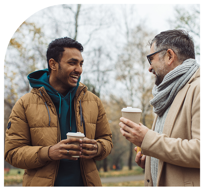 Two men having coffee in a park