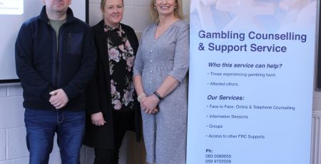 Gambling and addiction host members standing for a photo